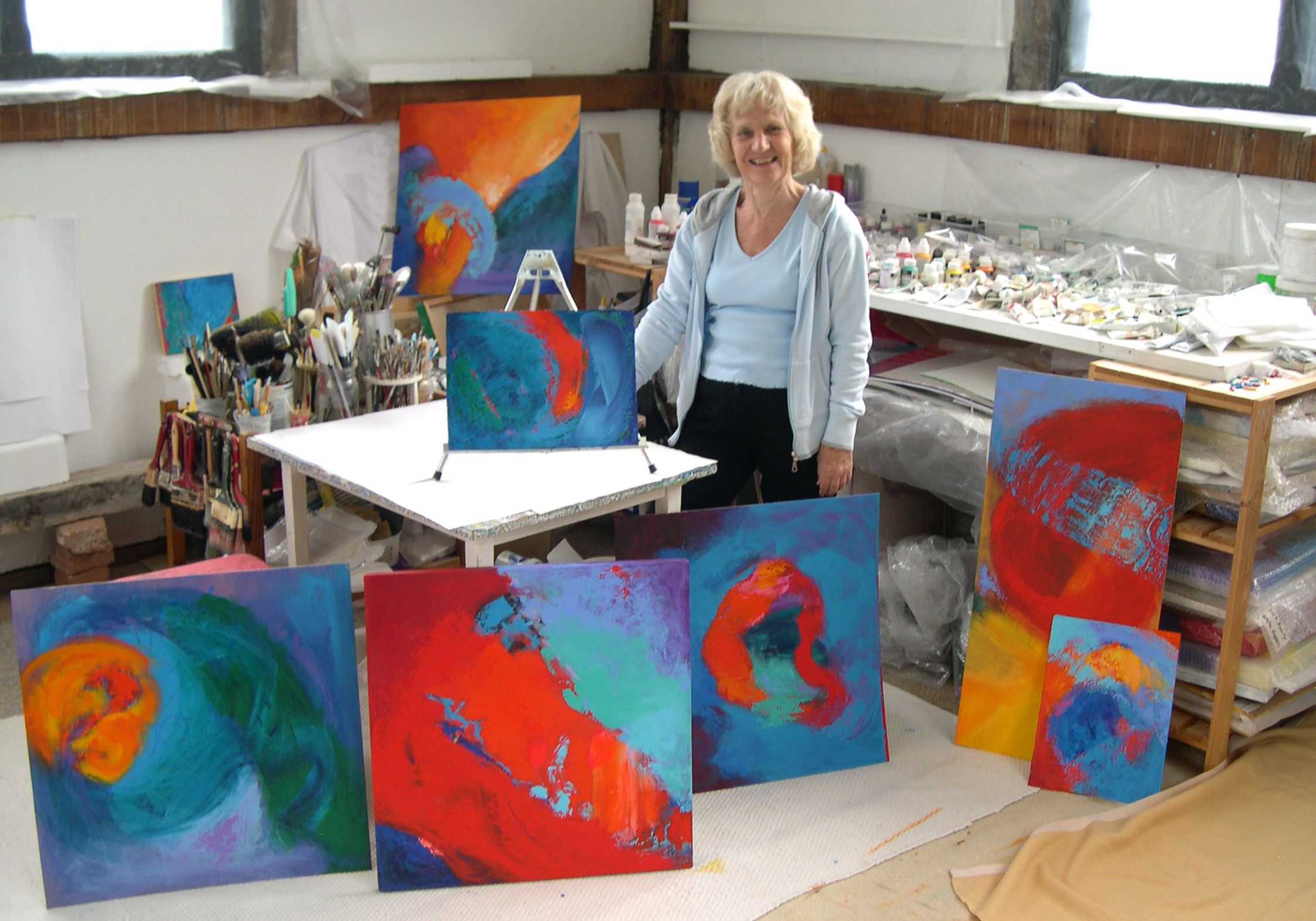 Stella Hidden in her studio with paintings