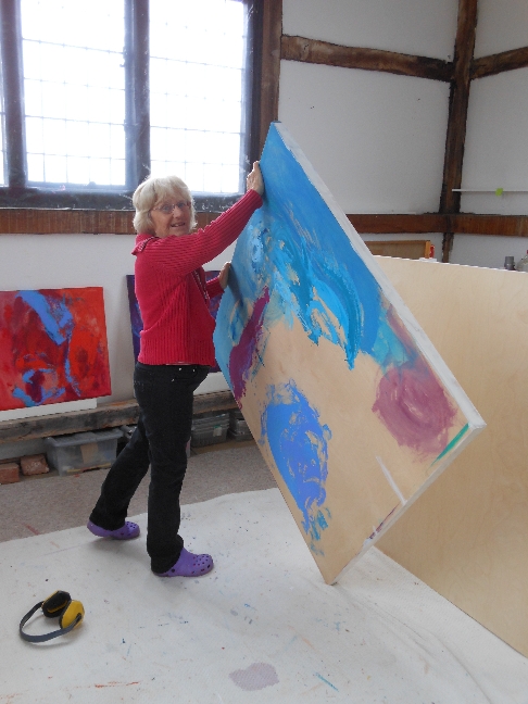 Movie or video of UK artist Stella Hidden at work creating colorful acrylic abstract paintings
